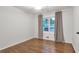 Bright bedroom featuring hardwood floors, ceiling fan, and large window with curtains at 2070 Drew Valley Ne Rd, Brookhaven, GA 30319