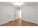 Bedroom with hardwood floors, closet, and neutral paint, providing a cozy atmosphere at 2070 Drew Valley Ne Rd, Brookhaven, GA 30319