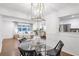 Stylish dining area with hardwood floors, modern lighting, and a seamless connection to the living room and kitchen at 2070 Drew Valley Ne Rd, Brookhaven, GA 30319