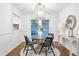 Elegant dining area featuring a modern light fixture, glass table, and French doors at 2070 Drew Valley Ne Rd, Brookhaven, GA 30319