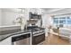 Modern kitchen features stainless steel appliances and granite countertops, seamlessly connected to the living area at 2070 Drew Valley Ne Rd, Brookhaven, GA 30319