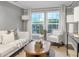 Inviting living room features painted brick walls, large windows, and stylish decor, creating a comfortable and bright space at 2070 Drew Valley Ne Rd, Brookhaven, GA 30319