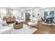 Open-concept living area with hardwood floors, modern furnishings, and a view of the kitchen and dining area at 2070 Drew Valley Ne Rd, Brookhaven, GA 30319