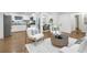 Spacious living area with hardwood floors, modern decor, and seamless flow to the kitchen and dining area at 2070 Drew Valley Ne Rd, Brookhaven, GA 30319