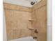 Close-up of shower with tiled walls, two shelves, and updated shower head at 2070 Drew Valley Ne Rd, Brookhaven, GA 30319