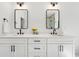 Bright bathroom features double vanity with white cabinets and black fixtures under contemporary lighting at 2860 3Rd Sw Ave, Atlanta, GA 30315