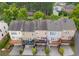 Aerial view of townhomes featuring rear decks, landscaping, and parking at 4879 Seldon Se Way, Smyrna, GA 30080