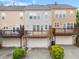 Rear of townhomes with decks, garages, and well-maintained landscaping and driveways at 4879 Seldon Se Way, Smyrna, GA 30080