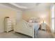 Comfortable bedroom features neutral walls, carpet, and furniture, well-lit by a bedside lamp at 4879 Seldon Se Way, Smyrna, GA 30080