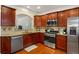 Bright kitchen features stainless steel appliances and dark wood cabinets at 4879 Seldon Se Way, Smyrna, GA 30080