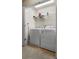 Functional laundry room equipped with a washer, dryer, and storage shelf for cleaning supplies at 4879 Seldon Se Way, Smyrna, GA 30080