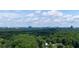 Scenic aerial view of a lush green landscape with a distant city skyline at 1648 Danbury Parc Ne Pl, Brookhaven, GA 30319