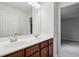 Bathroom features a double sink vanity, a large mirror, and updated lighting at 1648 Danbury Parc Ne Pl, Brookhaven, GA 30319
