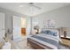 Stylishly staged bedroom with ceiling fan, neutral paint, and calming wall art at 1648 Danbury Parc Ne Pl, Brookhaven, GA 30319