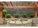 Relaxing fountain feature with a stone wall, complemented by landscaped shrubbery at 1648 Danbury Parc Ne Pl, Brookhaven, GA 30319
