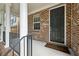 Welcoming front porch featuring brick accents, white columns, and a classic black front door at 1648 Danbury Parc Ne Pl, Brookhaven, GA 30319