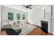 Bright living room with a fireplace, large windows, and hardwood floors with contemporary decor at 1648 Danbury Parc Ne Pl, Brookhaven, GA 30319