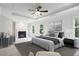 Spacious main bedroom featuring a tray ceiling, fireplace, and large windows for natural light at 1648 Danbury Parc Ne Pl, Brookhaven, GA 30319