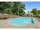 Inviting community pool with ample seating and a charming pool house nearby at 1648 Danbury Parc Ne Pl, Brookhaven, GA 30319