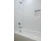 Bathroom featuring a white tiled shower, white tub, and a built-in niche for bathroom accessories at 2164 James Aly, Atlanta, GA 30345
