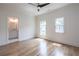 Neutral bedroom featuring wood floors, ceiling fan, and ensuite bathroom at 2164 James Aly, Atlanta, GA 30345