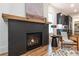 Modern fireplace features a black surround, a wood mantel, and a comfortable sitting area at 2164 James Aly, Atlanta, GA 30345