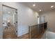 Upstairs hallway featuring hardwood floors and doorway access to a carpeted bedroom at 2164 James Aly, Atlanta, GA 30345