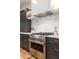 Close up view of the kitchen showing marble backsplash and stainless steel stove and range hood at 2164 James Aly, Atlanta, GA 30345