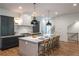 Open kitchen design with an island, bar stool seating, stainless steel appliances and pendant lighting at 2164 James Aly, Atlanta, GA 30345