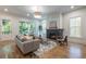 Cozy living room with large windows, hardwood floors, modern decor and a fireplace at 2164 James Aly, Atlanta, GA 30345