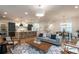 Open-concept living room with hardwood floors, modern decor, and an adjoining kitchen and dining area at 2164 James Aly, Atlanta, GA 30345