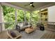 Screened porch with wicker furniture, ceiling fan and wooded views at 2164 James Aly, Atlanta, GA 30345