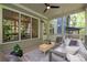 Screened porch with wicker furniture, ceiling fan and wooded backyard views at 2164 James Aly, Atlanta, GA 30345