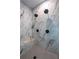 Close up on marble walled shower with bench, hexagon floor and matte black hardware at 2164 James Aly, Atlanta, GA 30345