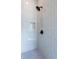 Modern shower featuring white vertical subway tile, black fixtures, and a built-in niche for toiletries at 2164 James Aly, Atlanta, GA 30345