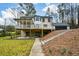 Spacious backyard featuring a raised deck, patio, and lush greenery creating a serene outdoor space at 805 Wesley Oak Rd, Atlanta, GA 30328