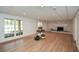 Spacious finished basement with a stylish brick fireplace and large windows for natural light at 805 Wesley Oak Rd, Atlanta, GA 30328