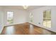Bright bedroom featuring hardwood floors, white walls, and multiple windows at 805 Wesley Oak Rd, Atlanta, GA 30328