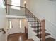 Welcoming foyer boasts hardwood floors, a staircase with wooden and metal railings, and a front door at 805 Wesley Oak Rd, Atlanta, GA 30328