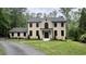 Beautiful, two-story brick home with manicured lawn, black windows, and a paved driveway at 805 Wesley Oak Rd, Atlanta, GA 30328