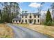 Classic brick home with a symmetrical facade, dark window frames, and an asphalt driveway at 805 Wesley Oak Rd, Atlanta, GA 30328