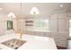 Bright kitchen featuring custom cabinets, a stainless steel sink, and modern lighting fixtures at 805 Wesley Oak Rd, Atlanta, GA 30328