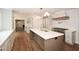 Spacious kitchen with stainless steel appliances, a large island, and hardwood flooring at 805 Wesley Oak Rd, Atlanta, GA 30328