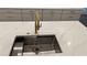 Close-up of a kitchen sink with a modern faucet and stainless steel drain at 805 Wesley Oak Rd, Atlanta, GA 30328