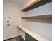 This laundry room features upper shelves, a countertop and cabinets for storage at 805 Wesley Oak Rd, Atlanta, GA 30328
