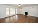 Spacious living room with hardwood floors, fireplace, and French doors leading to outdoor space at 805 Wesley Oak Rd, Atlanta, GA 30328