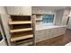 Large custom pantry with multiple sliding shelves for easy access and kitchen storage at 805 Wesley Oak Rd, Atlanta, GA 30328