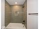 Shower stall with green vertical tiles, black fixtures, and recessed niche at 805 Wesley Oak Rd, Atlanta, GA 30328