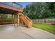 Backyard view of second-level deck, staircase, and manicured lawn with perimeter privacy fence at 1235 Renaissance Se Ct, Mableton, GA 30126