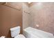 Cozy bathroom features a toilet, a bathtub with tiled walls, and a towel rack at 1235 Renaissance Se Ct, Mableton, GA 30126